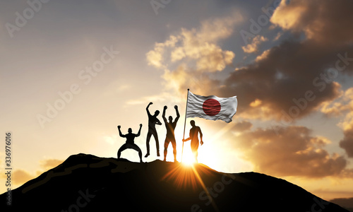 A group of people celebrate on a mountain top with Japan flag. 3D Render