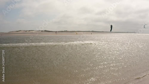 People kite sufring with hard wind on the ocean photo