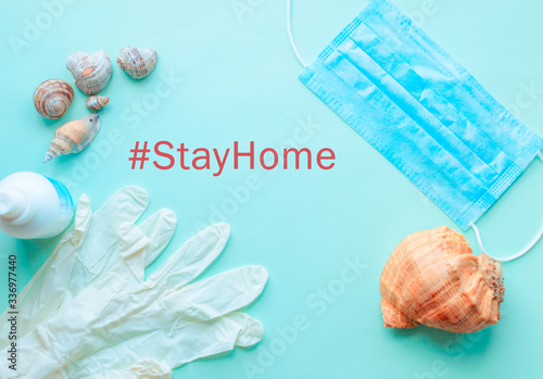 Summer vacation, beach rest and medical protective mask, gloves, antiseptic on mint blue background. Coronavirus covid-19 travel. Flat lay. Copy space. pandemic quarantine self isolation, 2019-nCoV