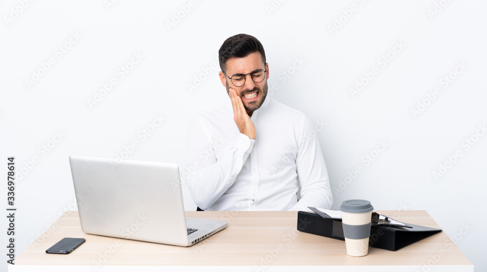 Young businessman in a workplace with toothache Young businessman in a workplace with toothache