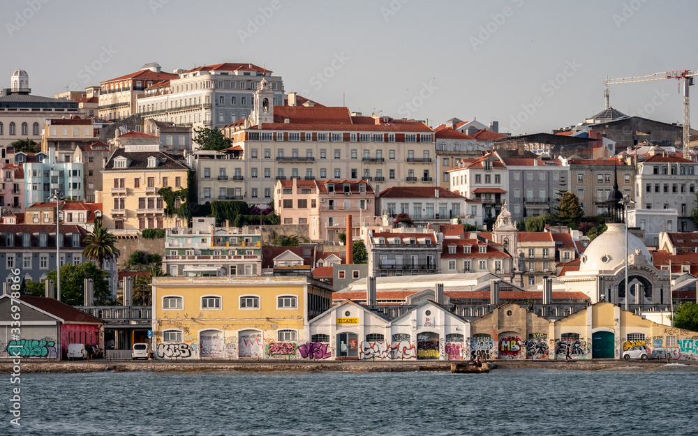 The buildings of Lisbon rising from the banks of the Tagus River up through the steep hill streets.