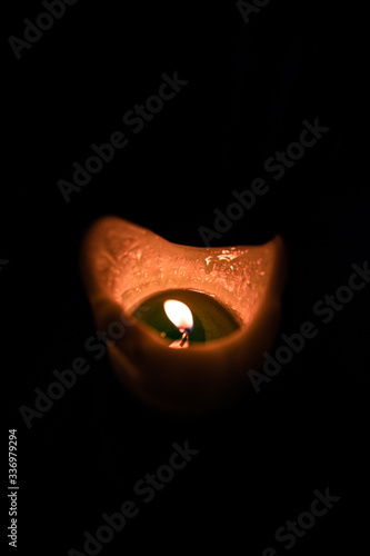 Candle burning flame in the dark. View of the full candle. Wide angle © Gorka