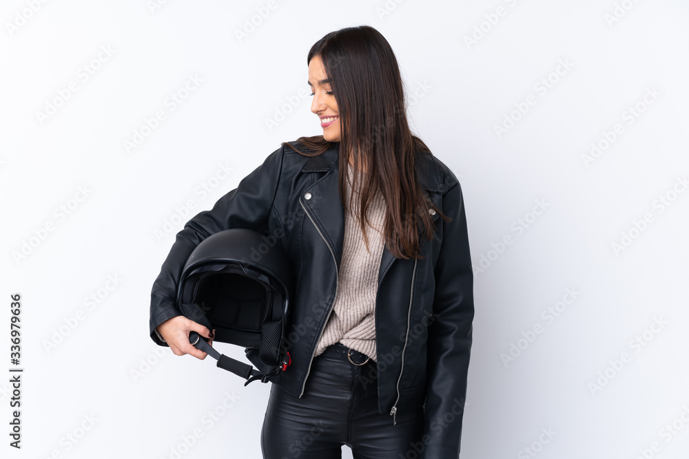 Young brunette woman with a motorcycle helmet over isolated white background with happy expression Young brunette woman with a motorcycle helmet over isolated white background with happy expression