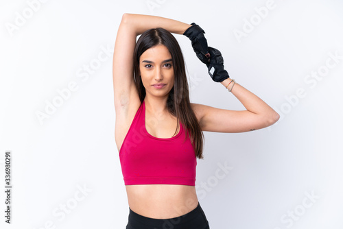Fototapeta Naklejka Na Ścianę i Meble -  Young sport brunette woman over isolated white background stretching