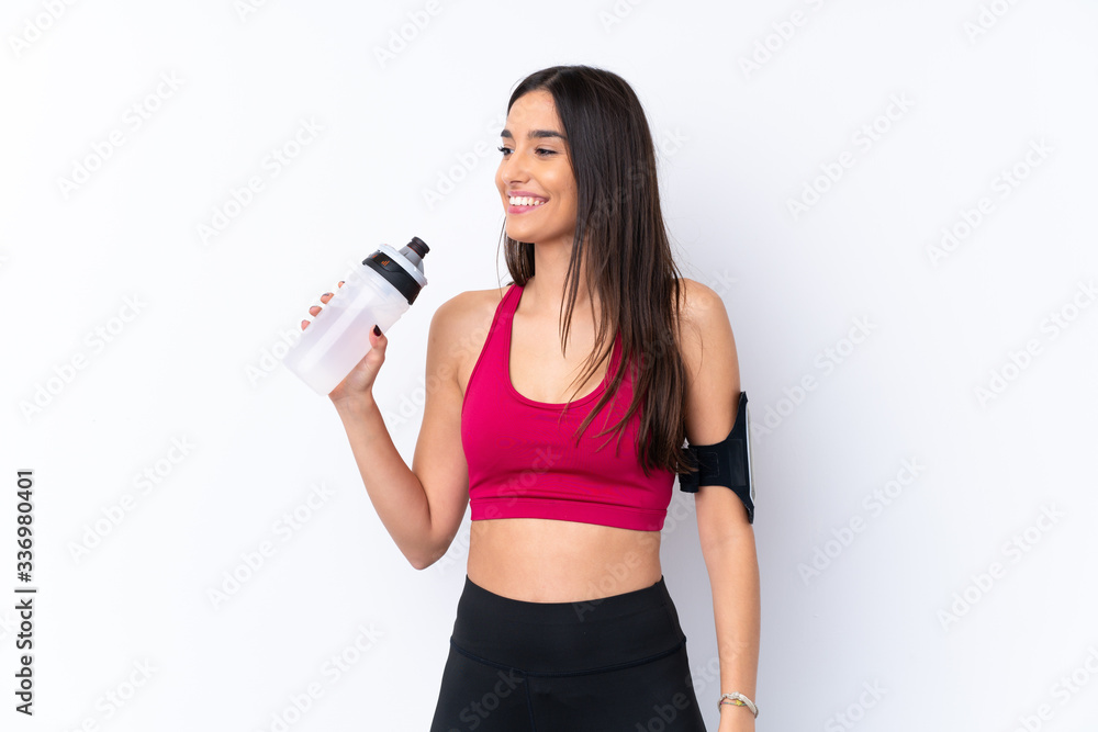 Young sport brunette woman over isolated white background with sports water bottle Young sport brunette woman over isolated white background with sports water bottle