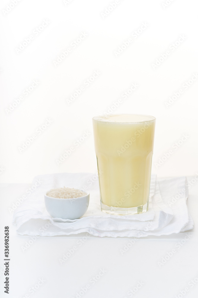 Dairy alternative. Rice milk in a high glass on white background. Dairy alternative. Rice milk in a high glass on white background.