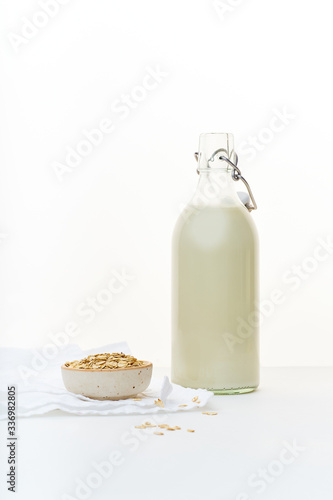 Oat milk in a glass bottle. Dairy alternative. Healthy vegan protein drink