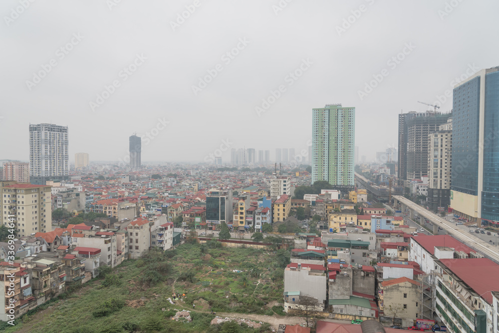 Polluted air near under construction elevated highways and skyscrapers in the East of Hanoi