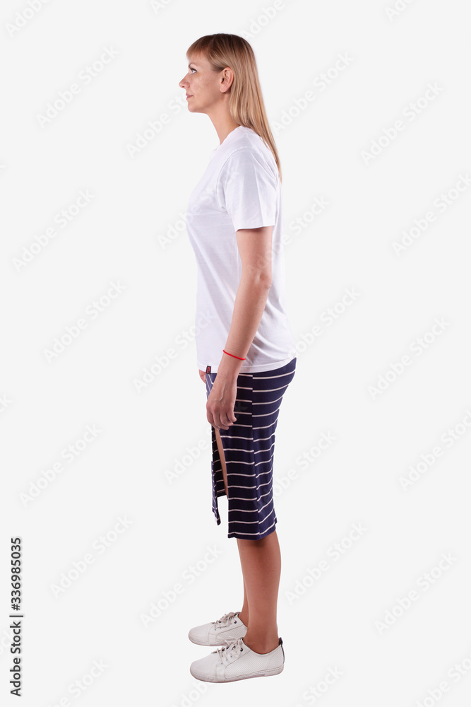 Caucasian woman stands sideways to camera and looks straight ahead. Full length Caucasian woman stands sideways to camera and looks straight ahead. Full length