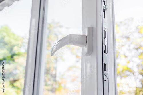 Open plastic vinyl pvc window on a background forest