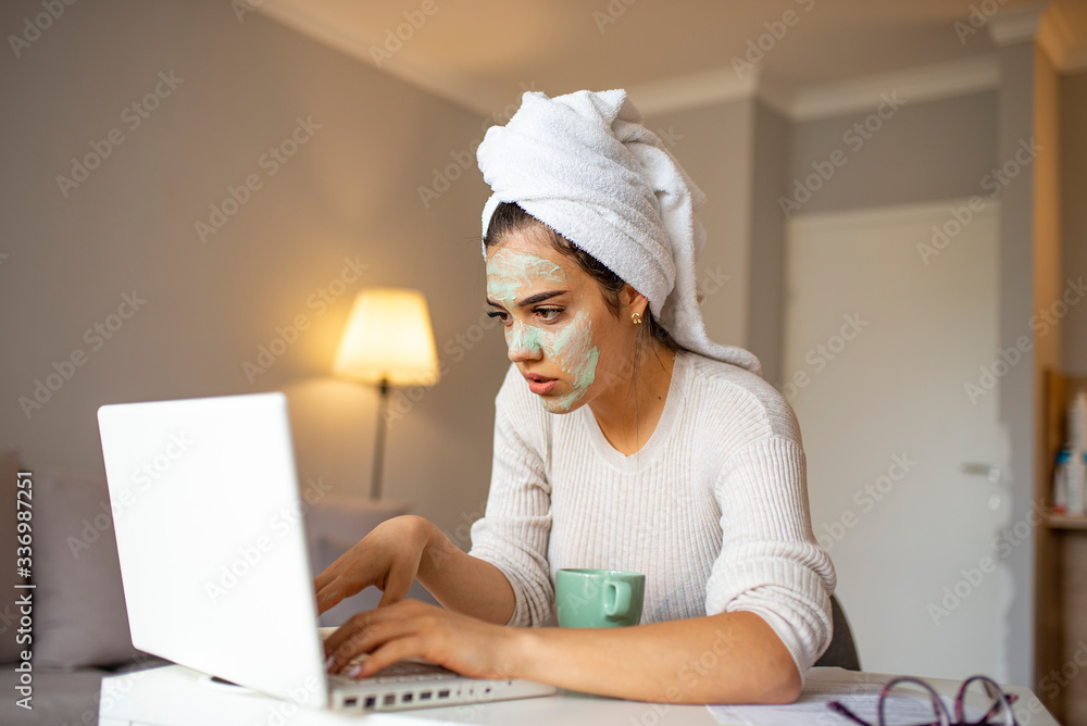 Beautiful business woman working on a laptop sitting at the table in living room of modern home. Stay home and self isolation quarantine covid-19 concept. Home office Beautiful business woman working on a laptop sitting at the table in living room of modern home. Stay home and self isolation quarantine covid-19 concept. Home office