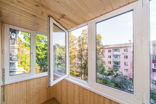 White metal-plastic windows of balcony in modern apartment