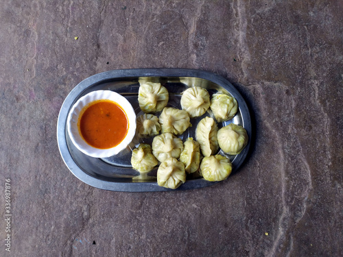 some fresh eatable food put in a plate with red chutney