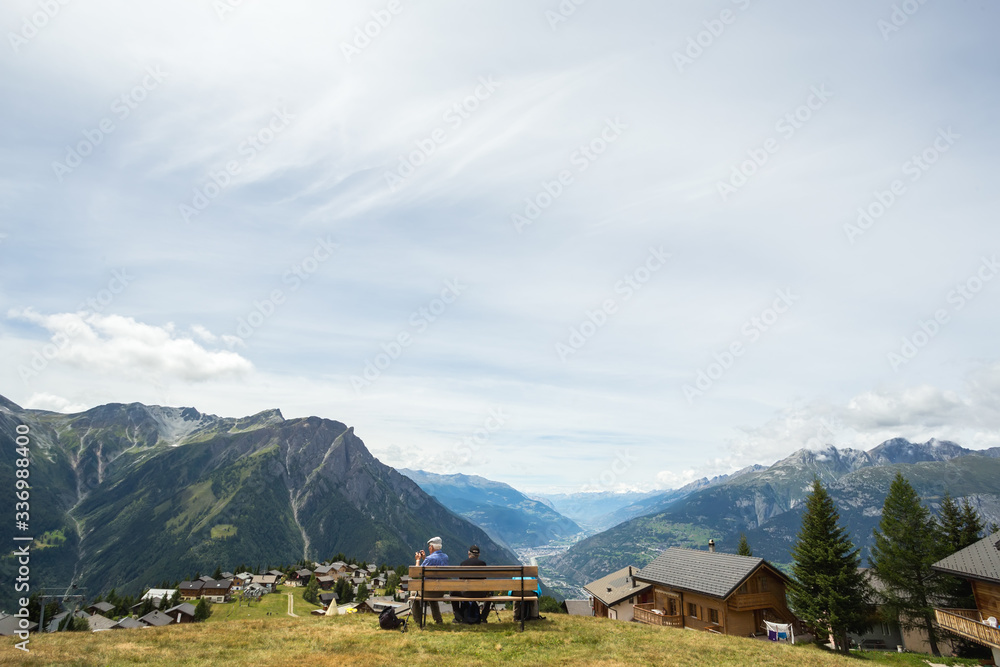 people on the bench, view of the valley in the mountains, switzerland, travel, trekking