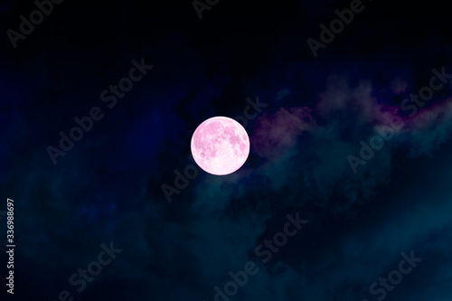 Big full bright pink purple magic moon with colorful clouds. Perigee night, lunar closest to Earth