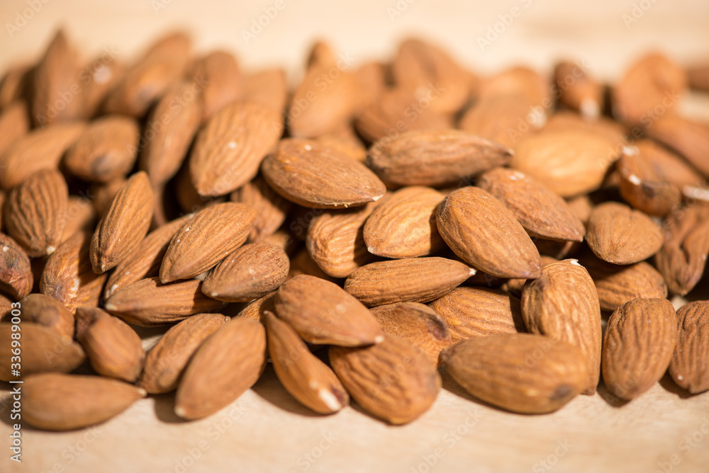 Group of raw shelled almonds from Sicily,, macro shot, horizontal view, selective focus. Group of raw shelled almonds from Sicily,, macro shot, horizontal view, selective focus.