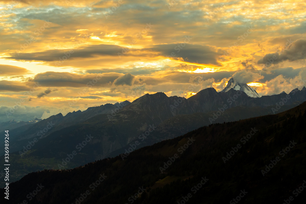 sunset in the mountains peak in switzerland summer