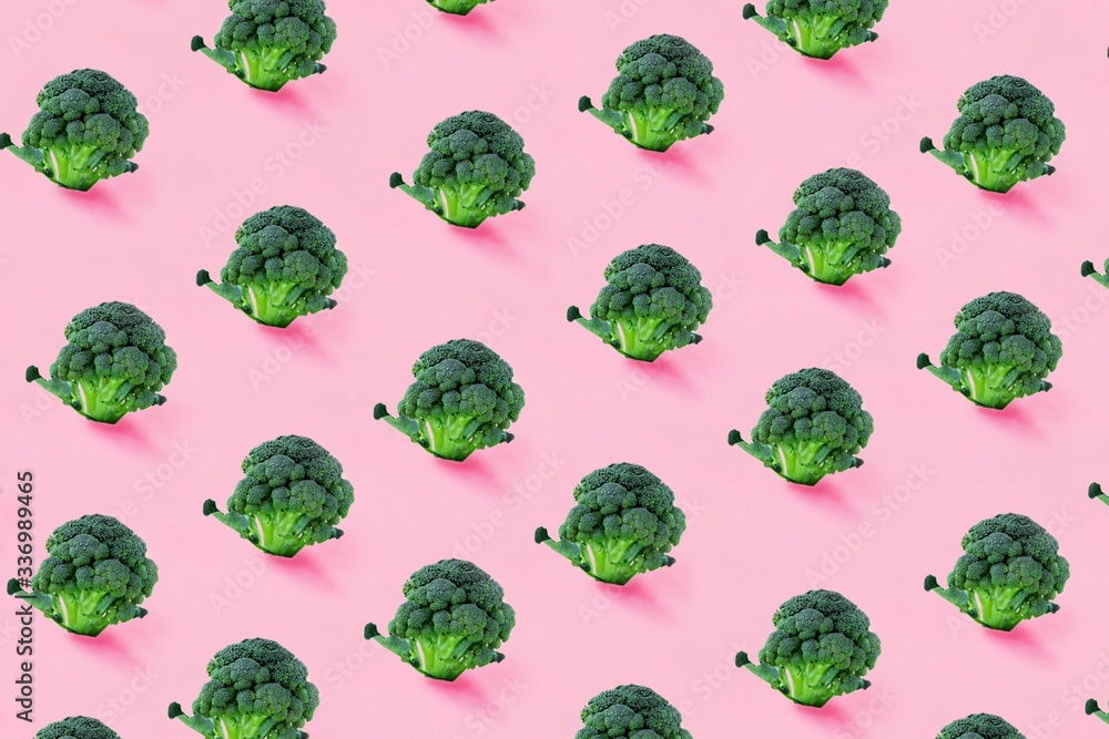Broccoli on a pink background. Seamless minimalistic isometric pattern, photo collage, vegan pop art design, vegetable backdrop. Postcard, print on fabric, wrapping paper. Broccoli on a pink background. Seamless minimalistic isometric pattern, photo collage, vegan pop art design, vegetable backdrop. Postcard, print on fabric, wrapping paper.