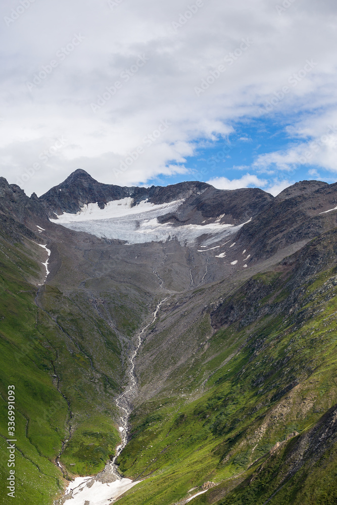 The mountains of Switzerland, the summits of the mountains with snow in summer