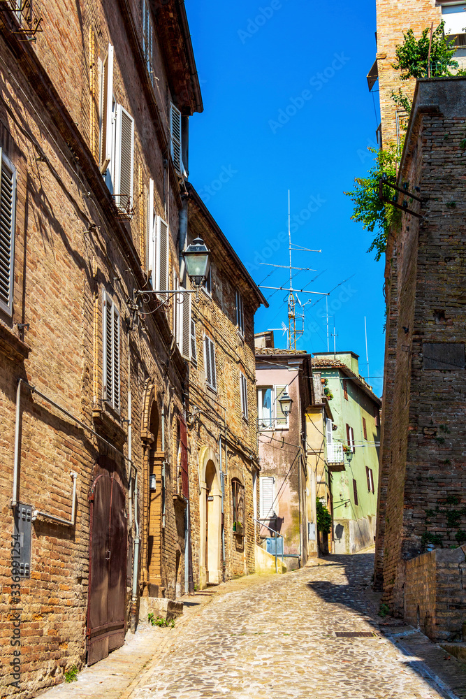View of a beautiful narrow cobbled street in Fermo, Province of Fermo, Marche Region, Italy