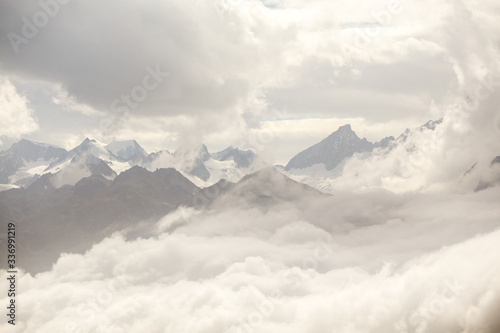 high in the mountains, peaks among the clouds, switzerland
