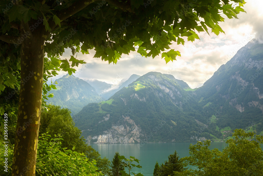 lake in the mountains of switzerland green mountains and sunshine