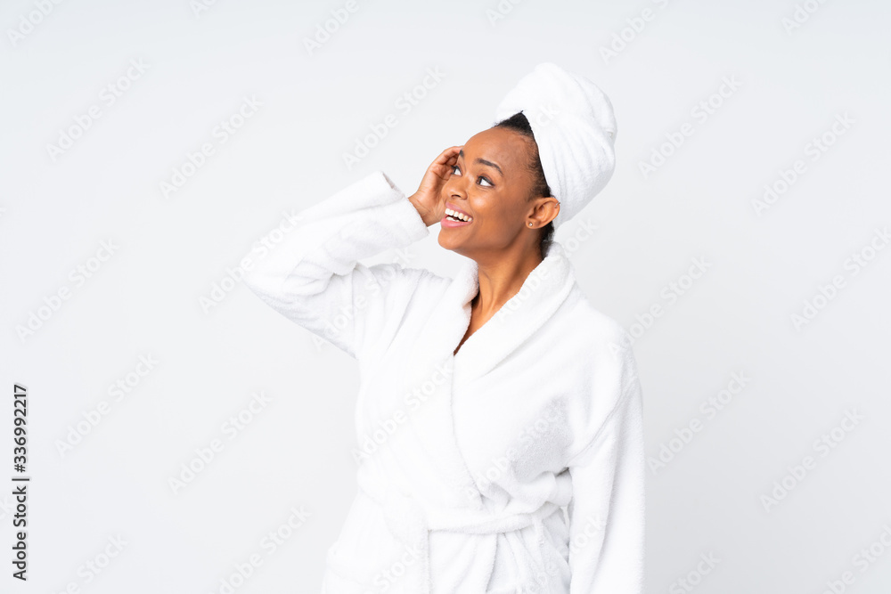 African american woman in a bathrobe over isolated background laughing African american woman in a bathrobe over isolated background laughing