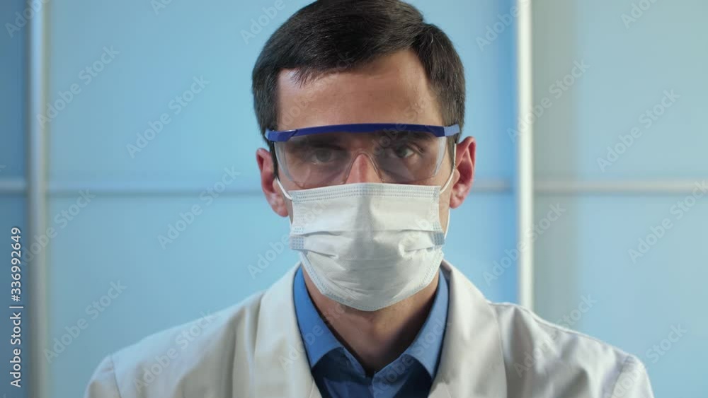 Physician in protective glasses and mask Physician in protective glasses and mask