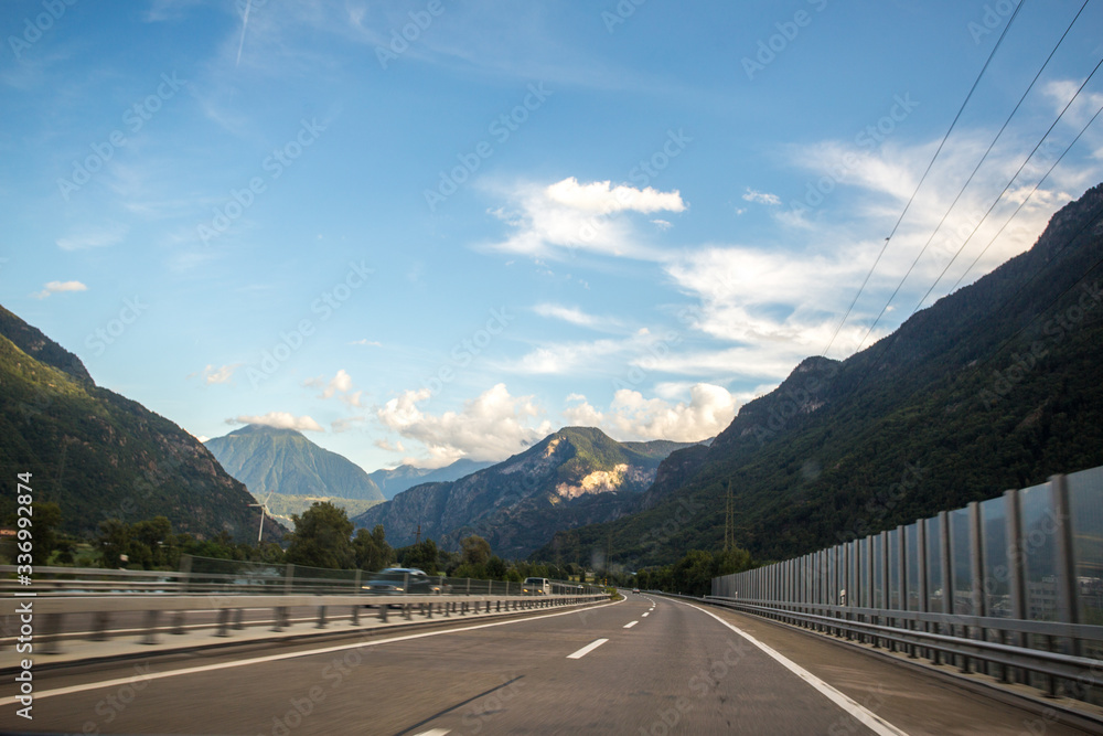 Asphalt road in Switzerland, road between the Alps mountains