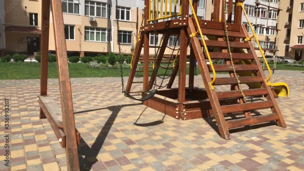 Children Empty swing in the yard of a high-rise building. Children Empty swing in the yard of a high-rise building.