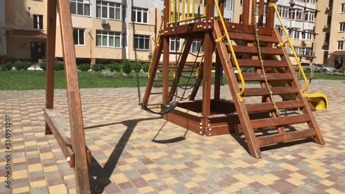 Children Empty swing in the yard of a high-rise building.