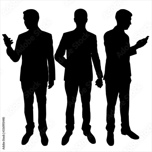 Vector illustration with a black male silhouette on a white isolated background. Man, guy holding a phone, looks at the phone, reads a message. Businessman in a suit steps with a gadget in his hands.