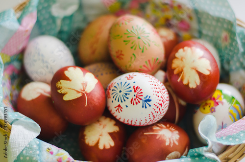 Colorful easter eggs in a basket. Colors made with natural ingredients and painted with wax. One of the easter tradition in Czech republic. Detailed view