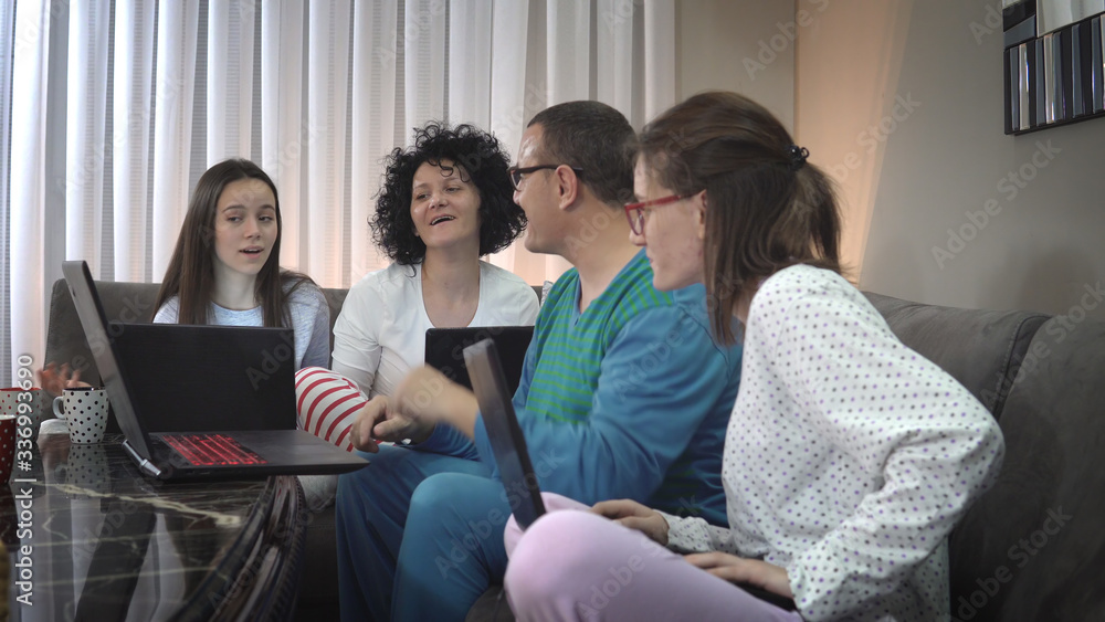 Family smart working and education with video conference. Sitting relaxed in pyjama at home preventing spread of corona covid-19 virus, world pandemia Family smart working and education with video conference. Sitting relaxed in pyjama at home preventing spread of corona covid-19 virus, world pandemia