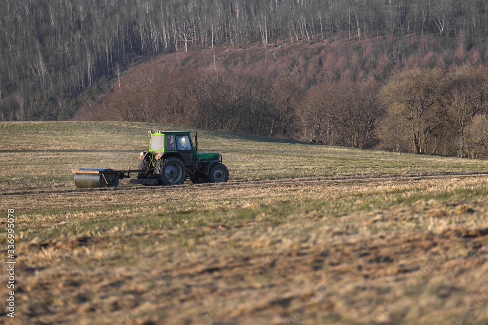 a tractor on a meadow in the evening a tractor on a meadow in the evening