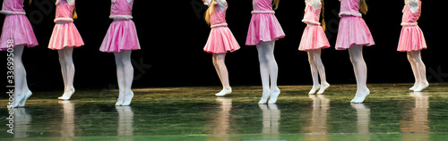 Children dance on stage in elegant clothes 