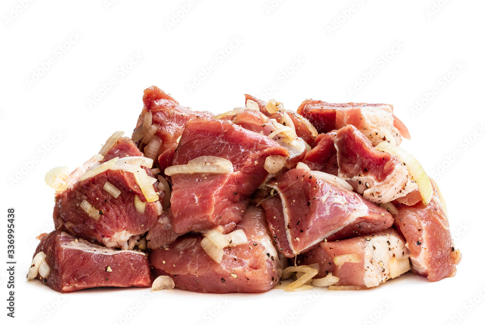 Marinated pork slices with onion and spices isolated on white