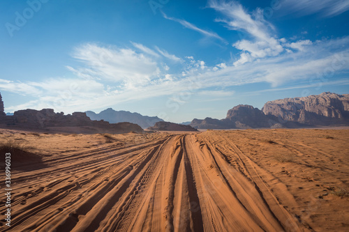 desert road in wadi rum, jeep traces in the sand