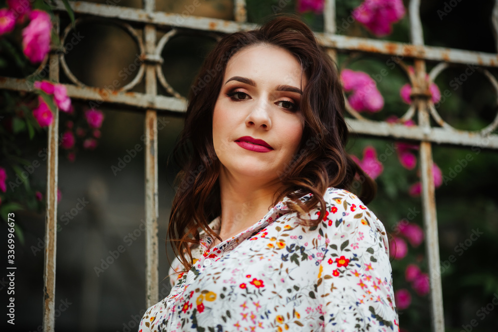 Fototapeta premium Portrait of beautiful brunette wearing evening makeup in dress