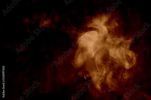 Orange smoke isolated on a black background. smoke image is like a ghost. Mystic
