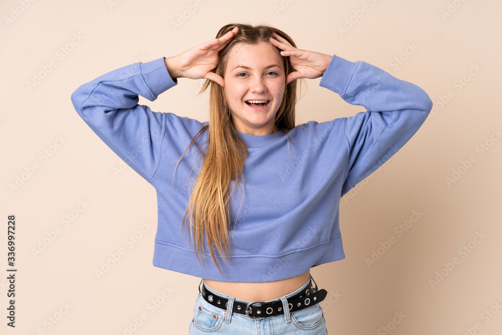 Teenager Ukrainian girl isolated on beige background with surprise expression Teenager Ukrainian girl isolated on beige background with surprise expression