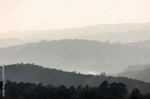 View of foggy forests in degrade mountains, several gray scale planes fading into the horizon
