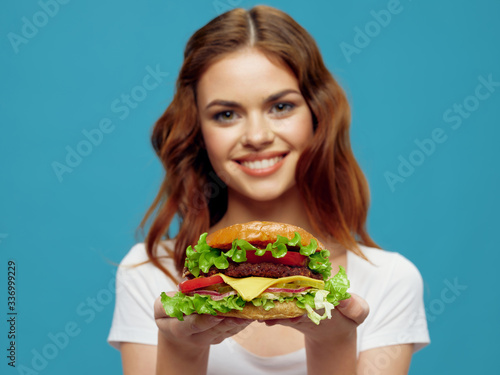 young woman holding a sandwich