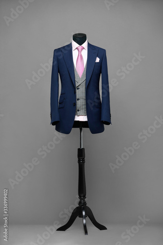 Atelier to repair clothes, Stylish look, Fashion look, Men look, Wedding style, Fashion concept, Brand clothing, Classic costume.Suit on black background. Store display. Classic style. Grey background