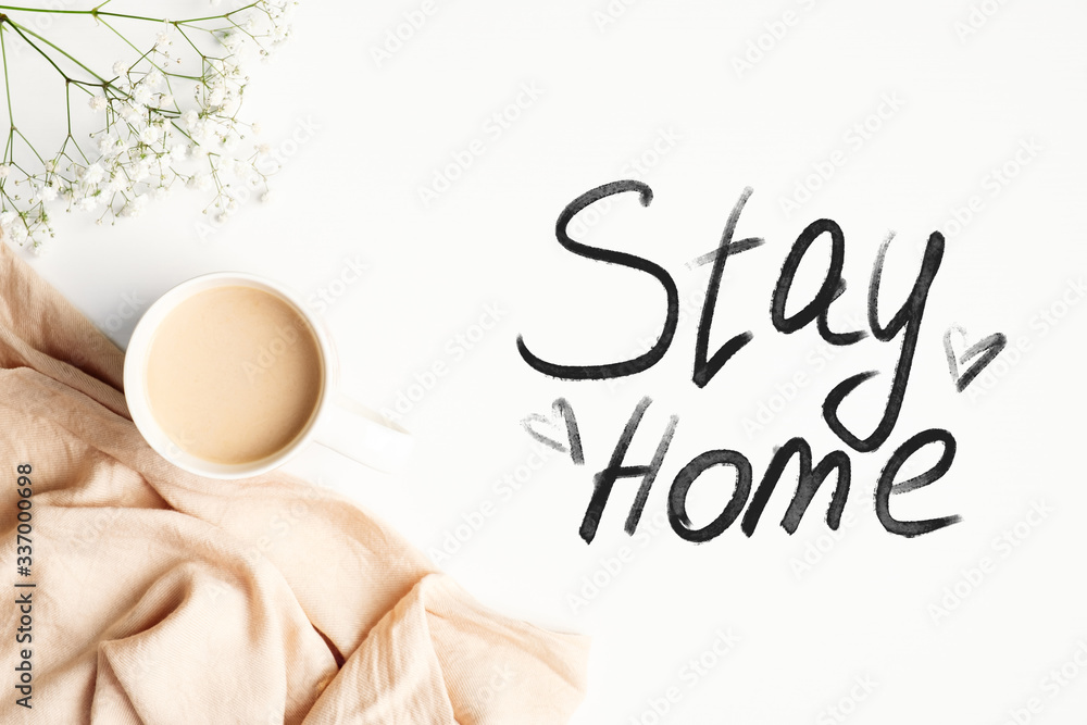 Obraz premium Stay home stay safe concept. Top view coffee cup, blanket and message