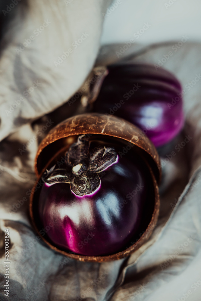 Fresh raw Purple Eggplant in a special wicker basket for Eggplant on gray background. Fresh raw Purple Eggplant in a special wicker basket for Eggplant on gray background.