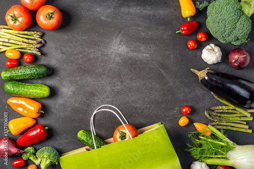 Exposition of fresh organic vegetables on black table. tomato  pepper  broccoli  onion  garlic  cucumber   eggplant  black Eyed Peas  ecological bag.