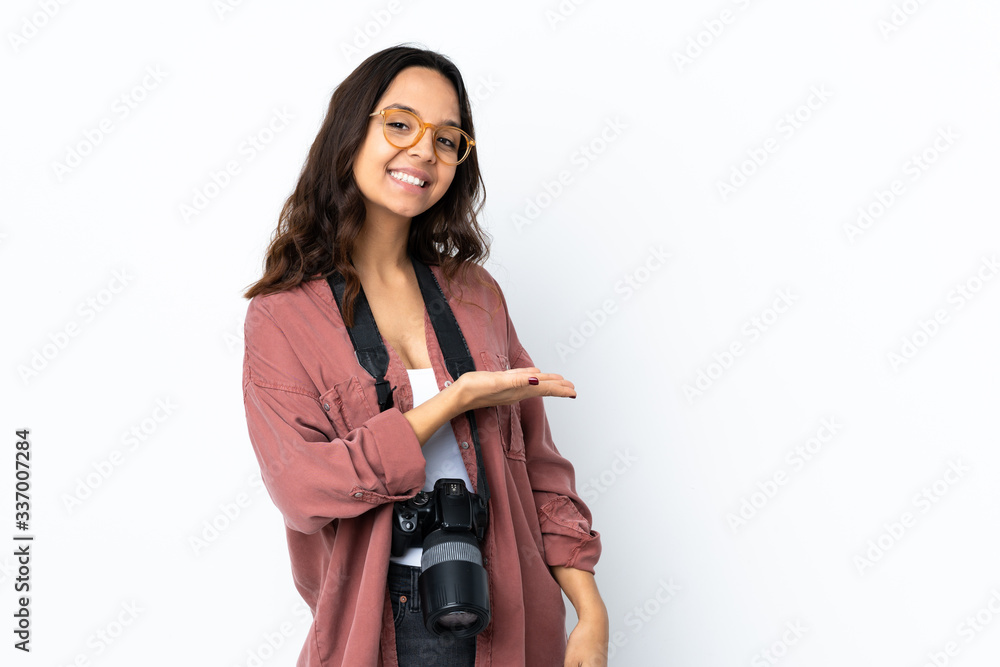 Young photographer woman over isolated white background presenting an idea while looking smiling towards Young photographer woman over isolated white background presenting an idea while looking smiling towards