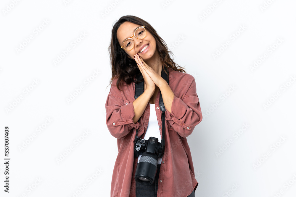 Young photographer woman over isolated white background keeps palm together. Person asks for something Young photographer woman over isolated white background keeps palm together. Person asks for something