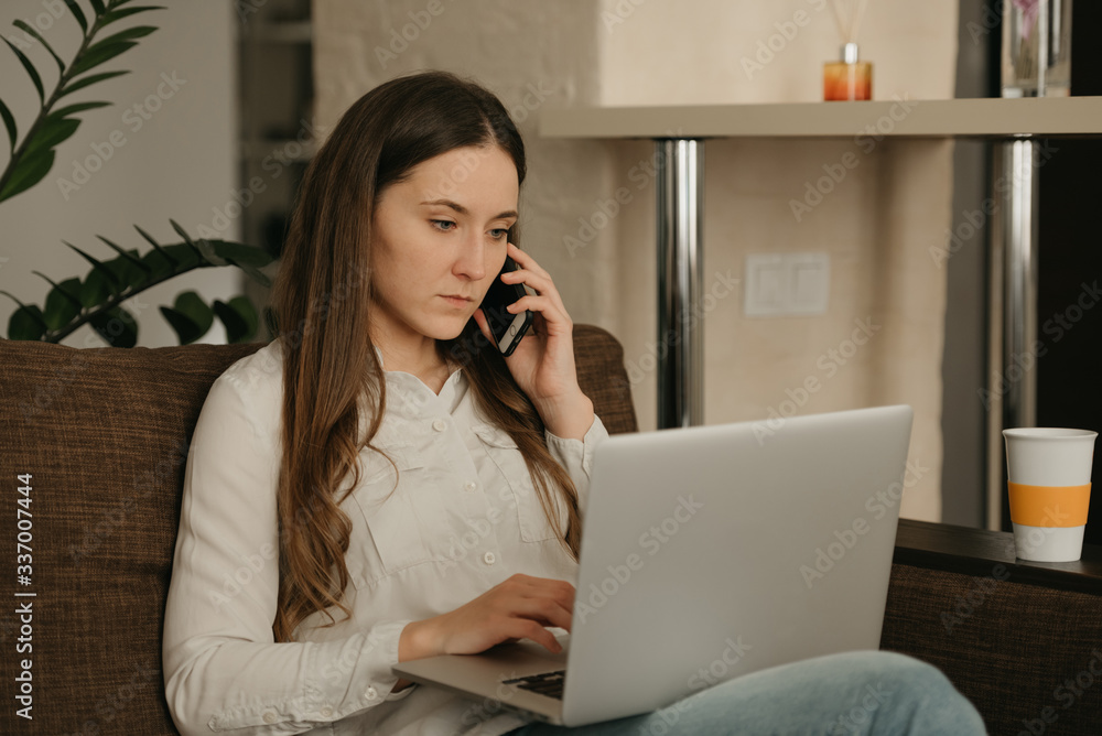 Remote work. A caucasian woman working remotely on her laptop. A businesswoman calls sitting on the couch at home. Remote work. A caucasian woman working remotely on her laptop. A businesswoman calls sitting on the couch at home.